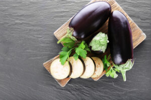 Fresh eggplant on a wooden cutting board